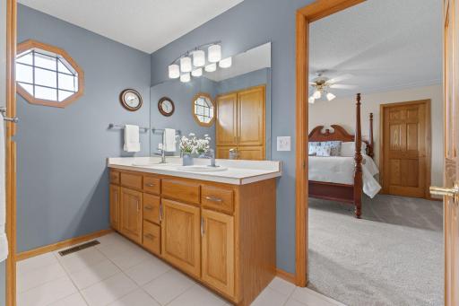 Primary master with tile floors and skylight for natural daylight.