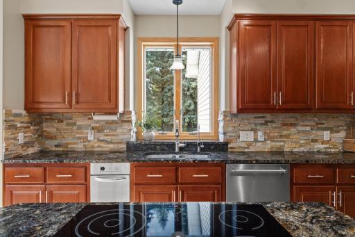 The stacked stone backsplash adds warmth and character to this lovely kitchen.