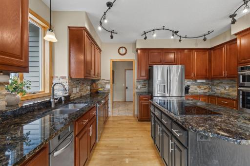Granite countertops, upgraded Kitchen Aid appliances and large center island make cooking a breeze!