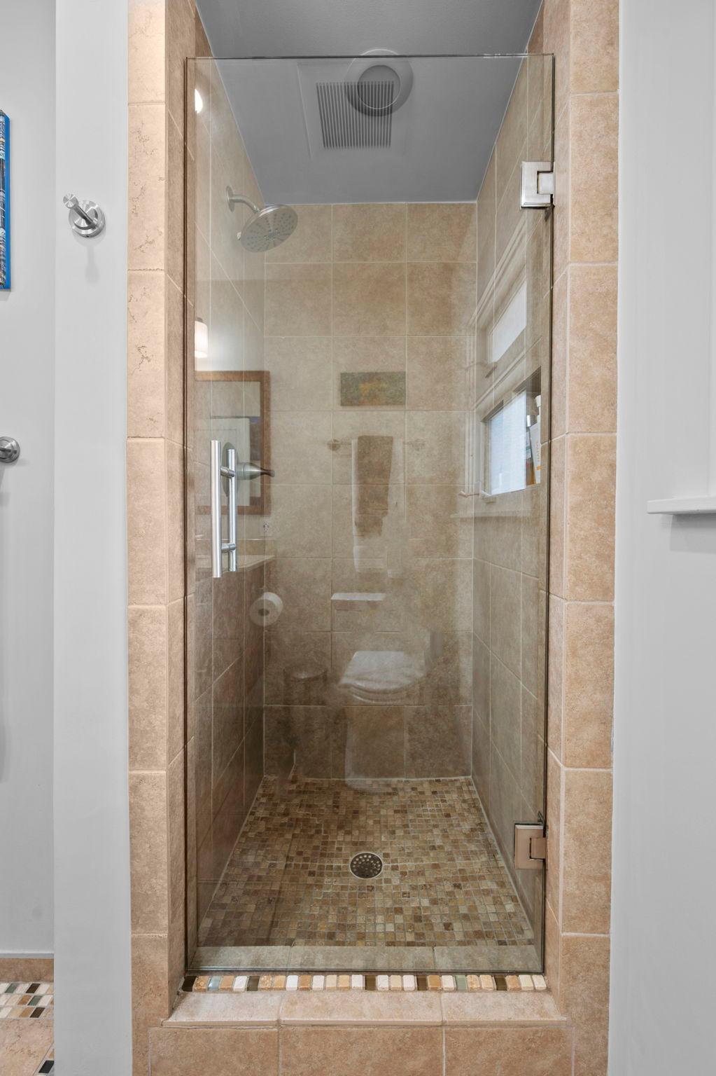 with tile floor and shower.
