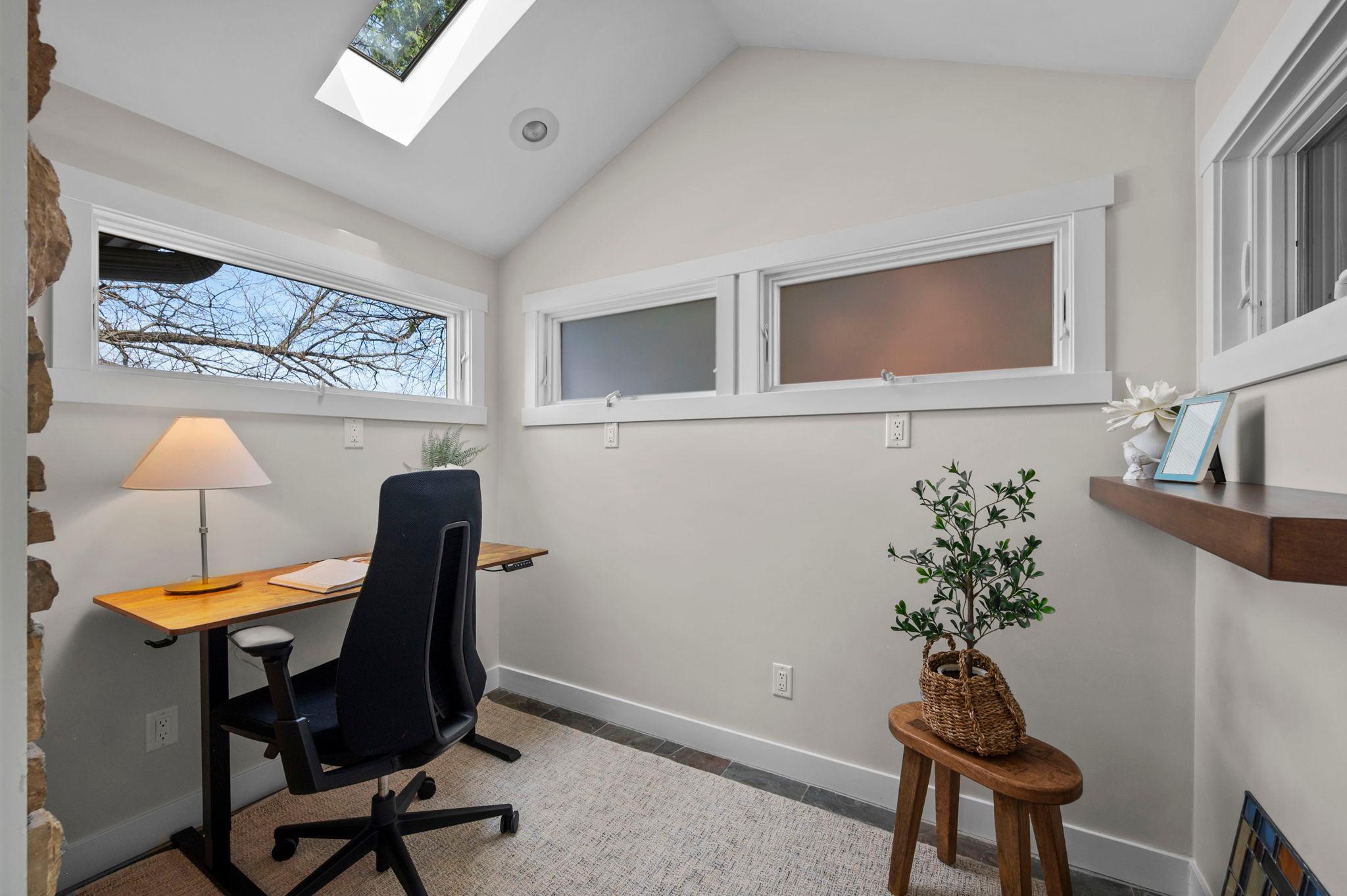 Daylight windows and skylight for ample natural light and added wall space.