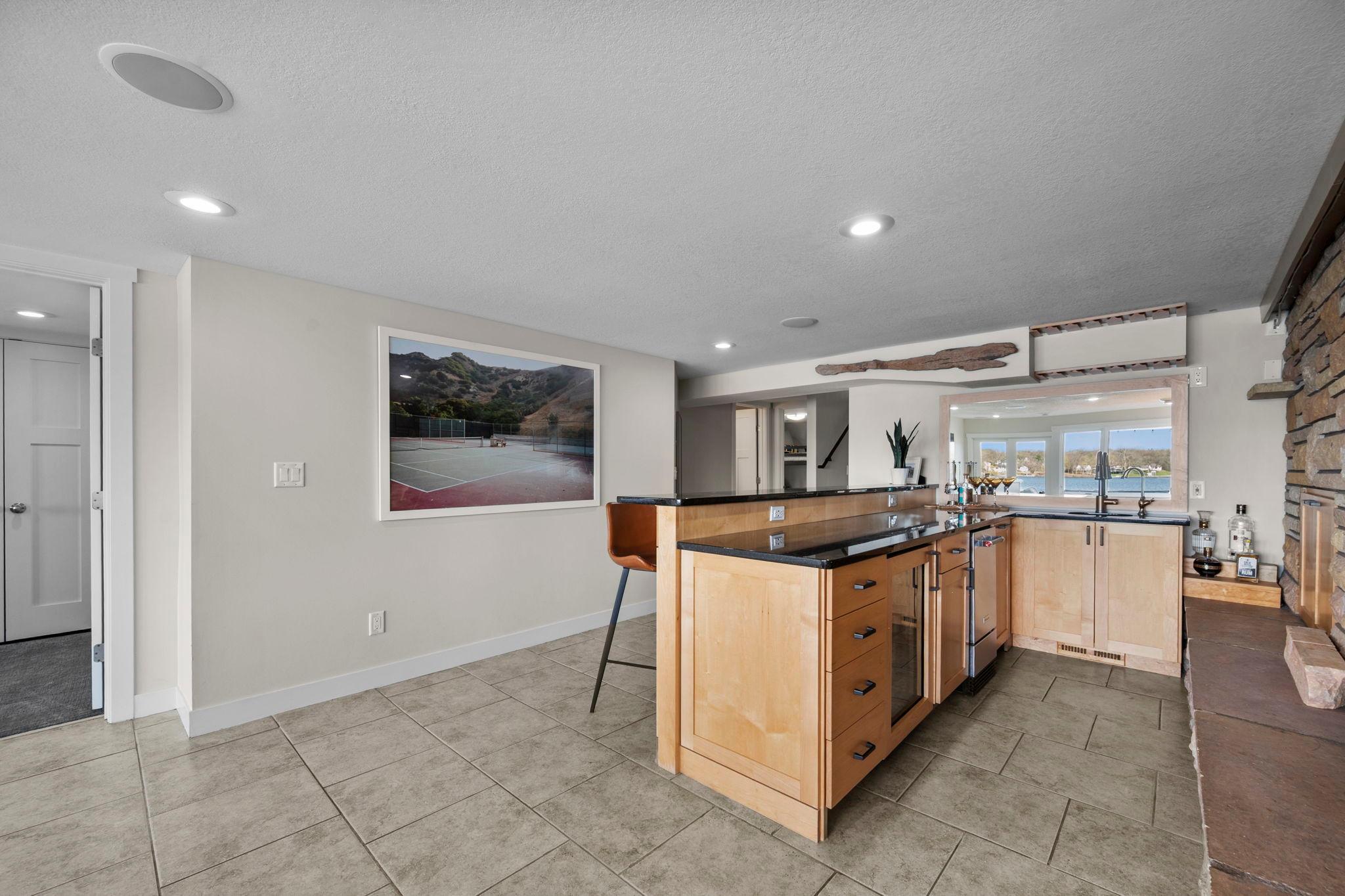 Granite countertop, ice maker and beveridge fridge.