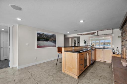 Granite countertop, ice maker and beveridge fridge.