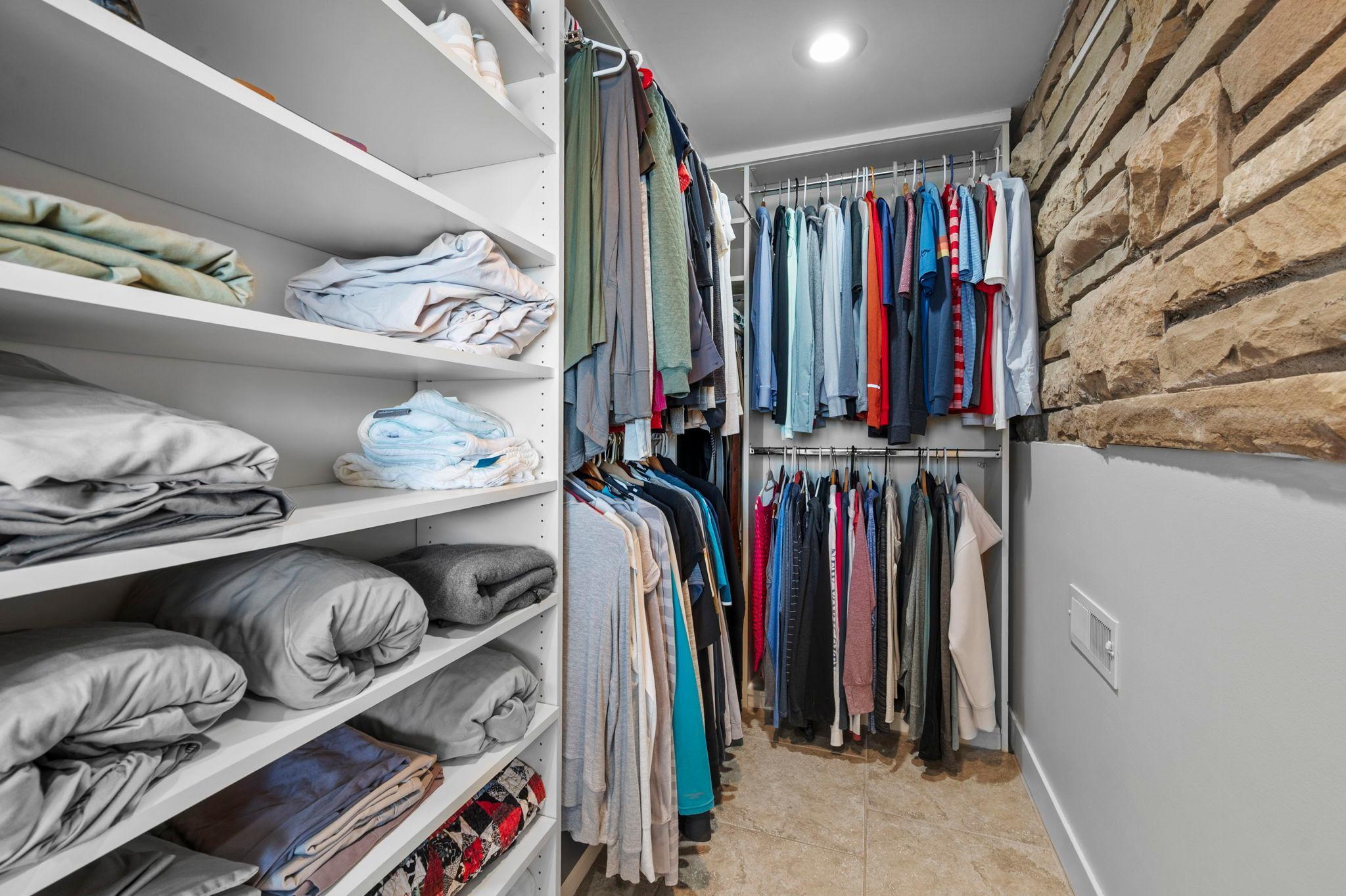 Primary bedroom custom walk-in closet.