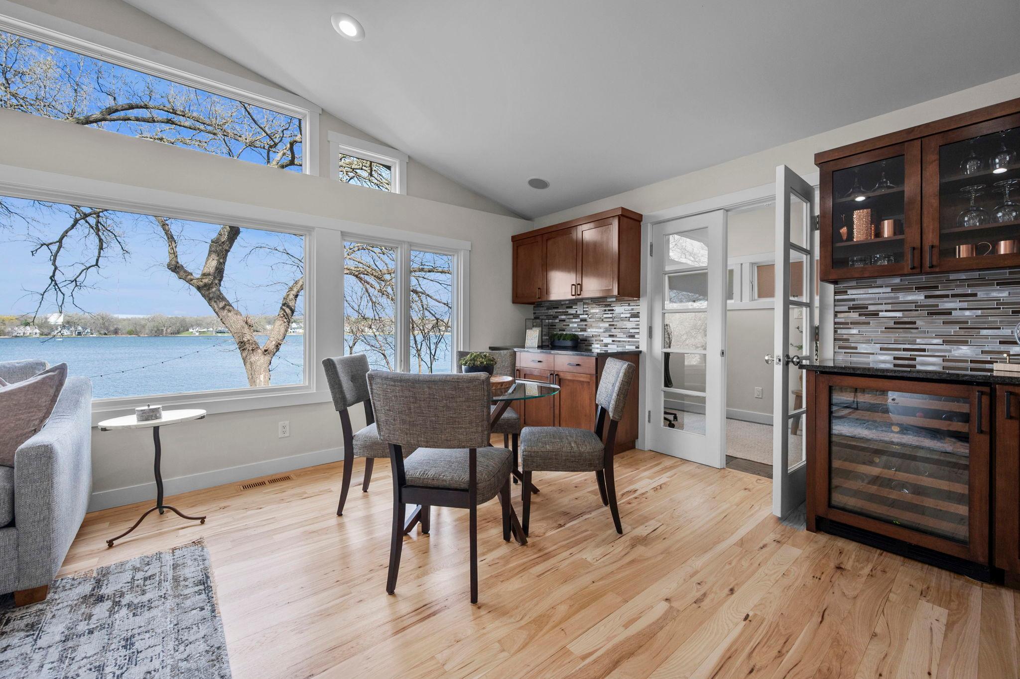 French doors and gleaming hardwood floors lead to den.