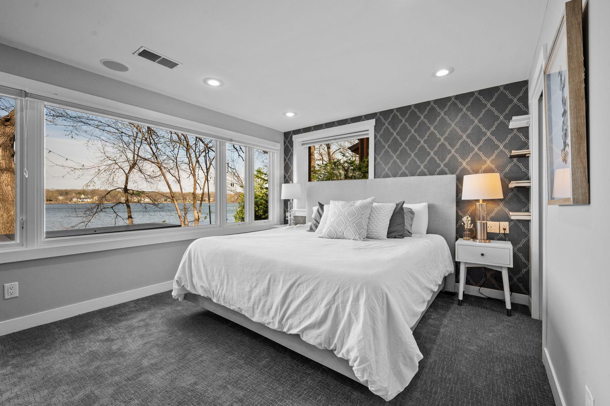 Primary bedroom with exceptional views of the lake.