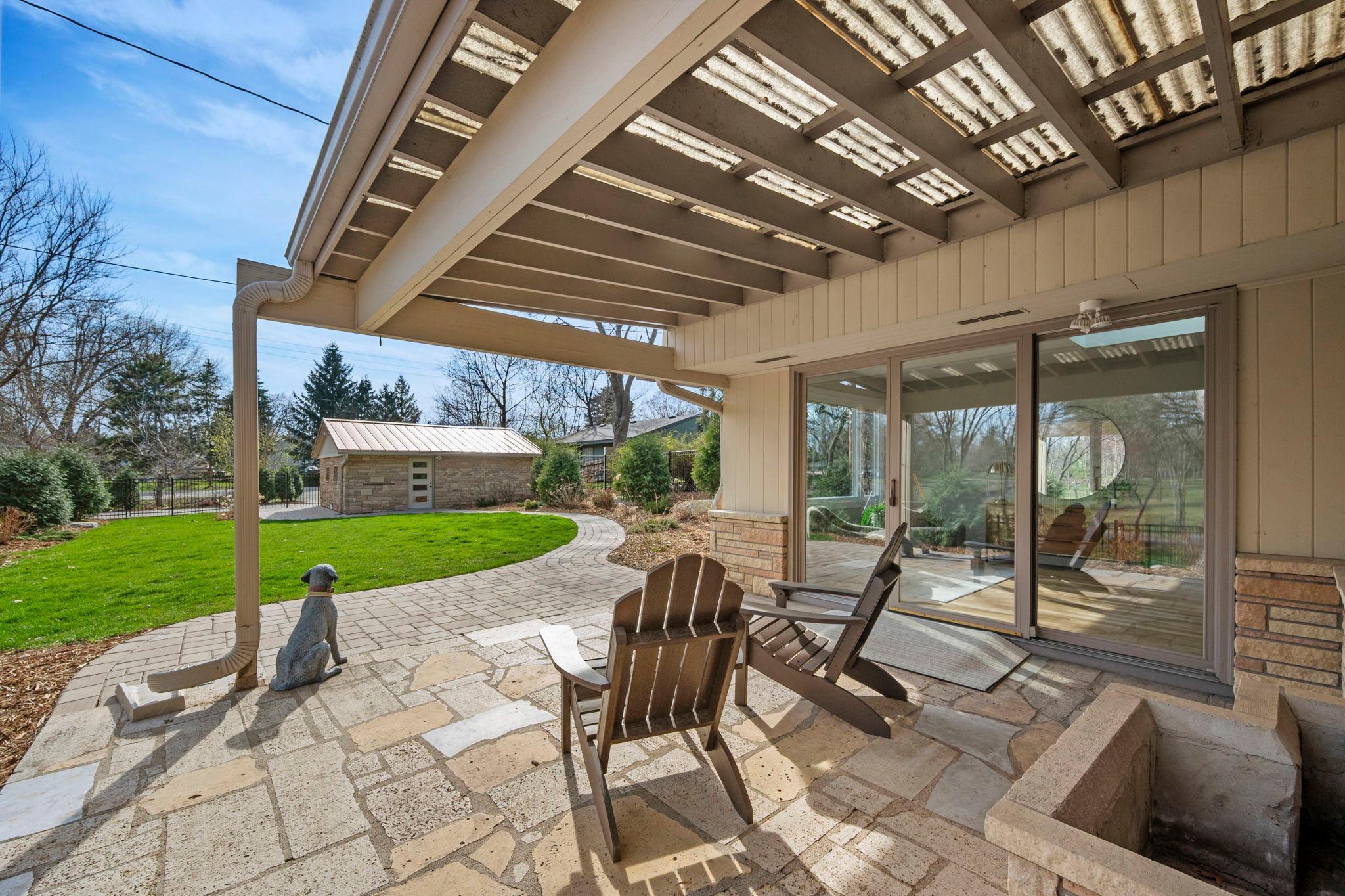 Paver patio at front of home with sliders into the home.