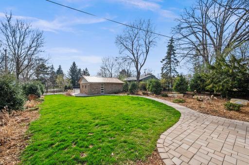 Paver patio and landscaping leading up to the home.