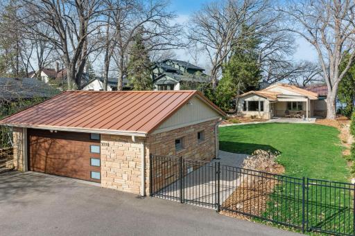 Wide paver patio extends from driveway all the way to the home.