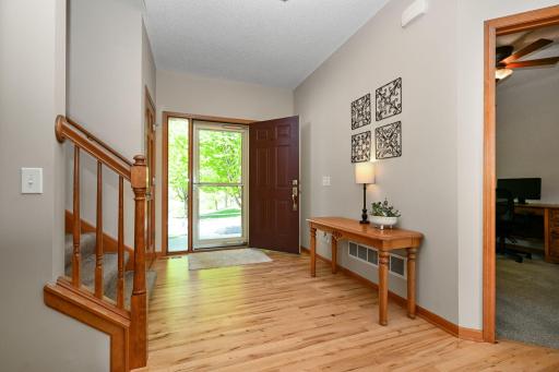 Spacious foyer with coat closet and beautiful hardwood floors.
