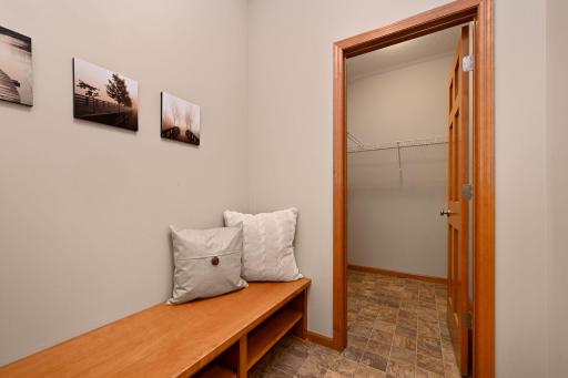 Entering from garage is handy bench and walk-in coat closet.