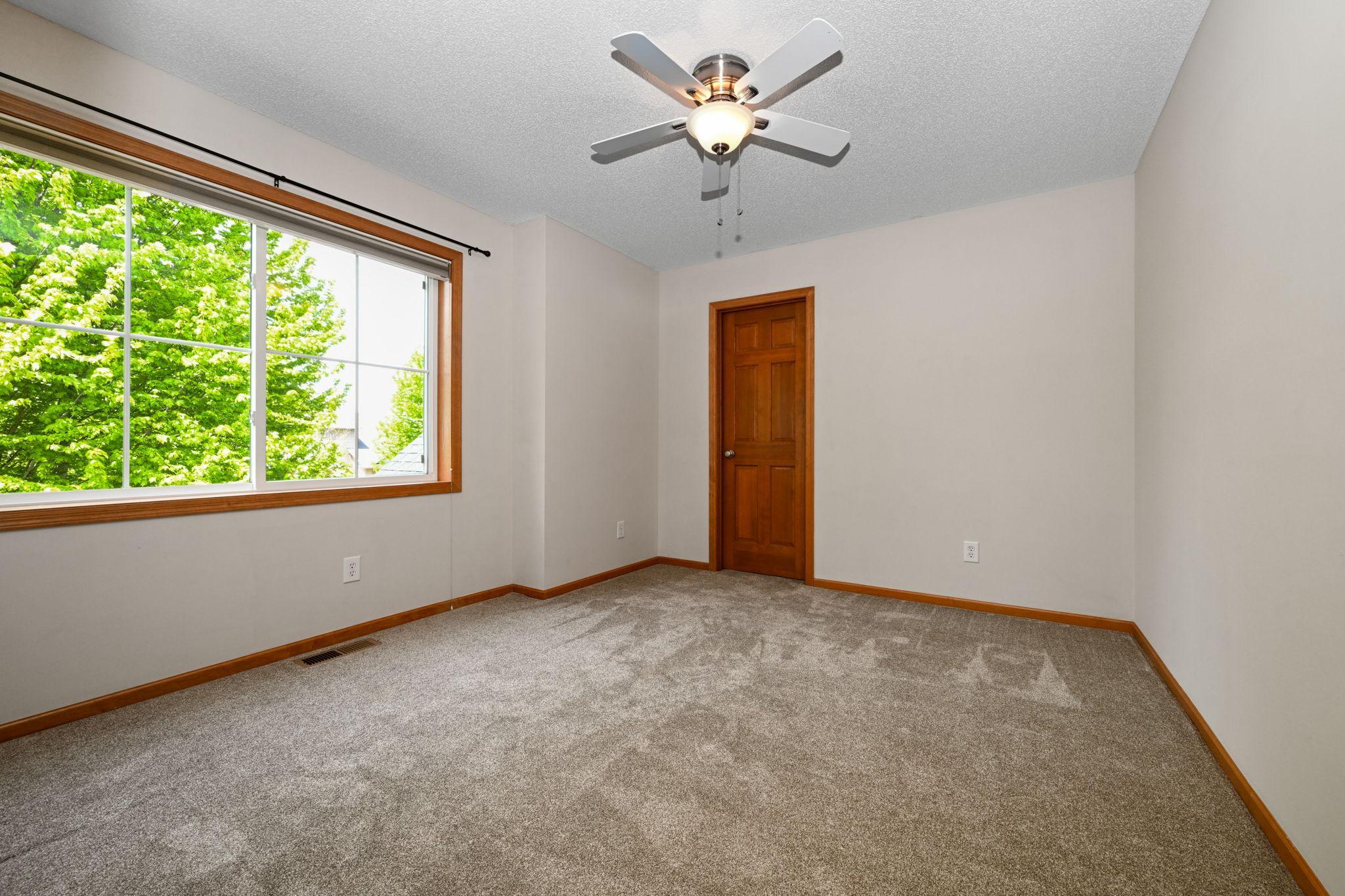 Upper bedroom #2 with walk-in closet & pond views.