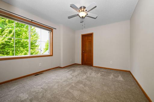 Upper bedroom #2 with walk-in closet & pond views.