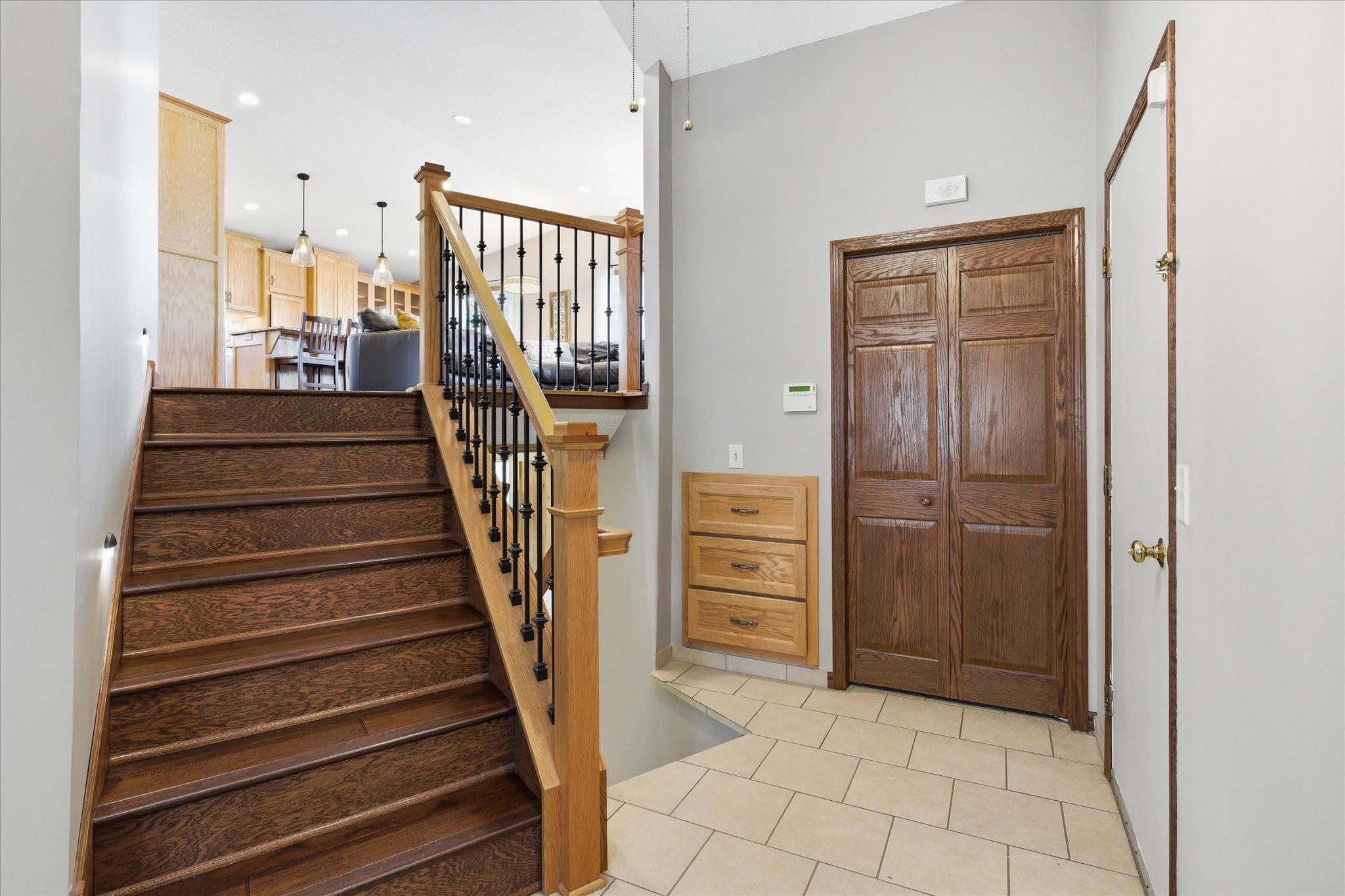This is definitely not a traditional split foyer with the angled staircases, tiled floors, and plenty of storage. Notice the beautiful woodwork!