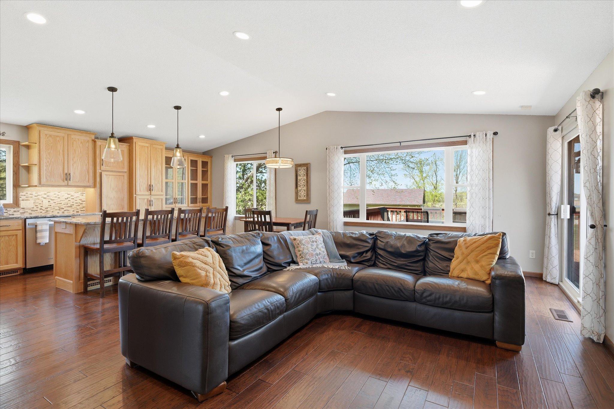 Walk up a few steps into this gorgeous living area with vaulted ceiling and engineered flooring plus the fully remodeled kitchen with custom cabinetry.