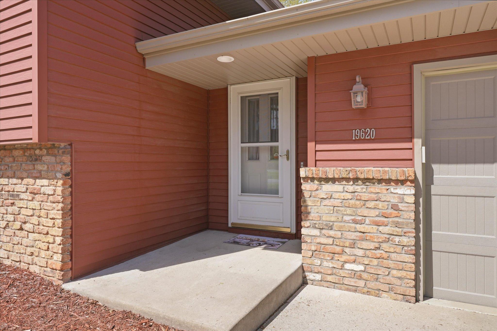 The inviting front entry area is covered to keep guests out of the elements.