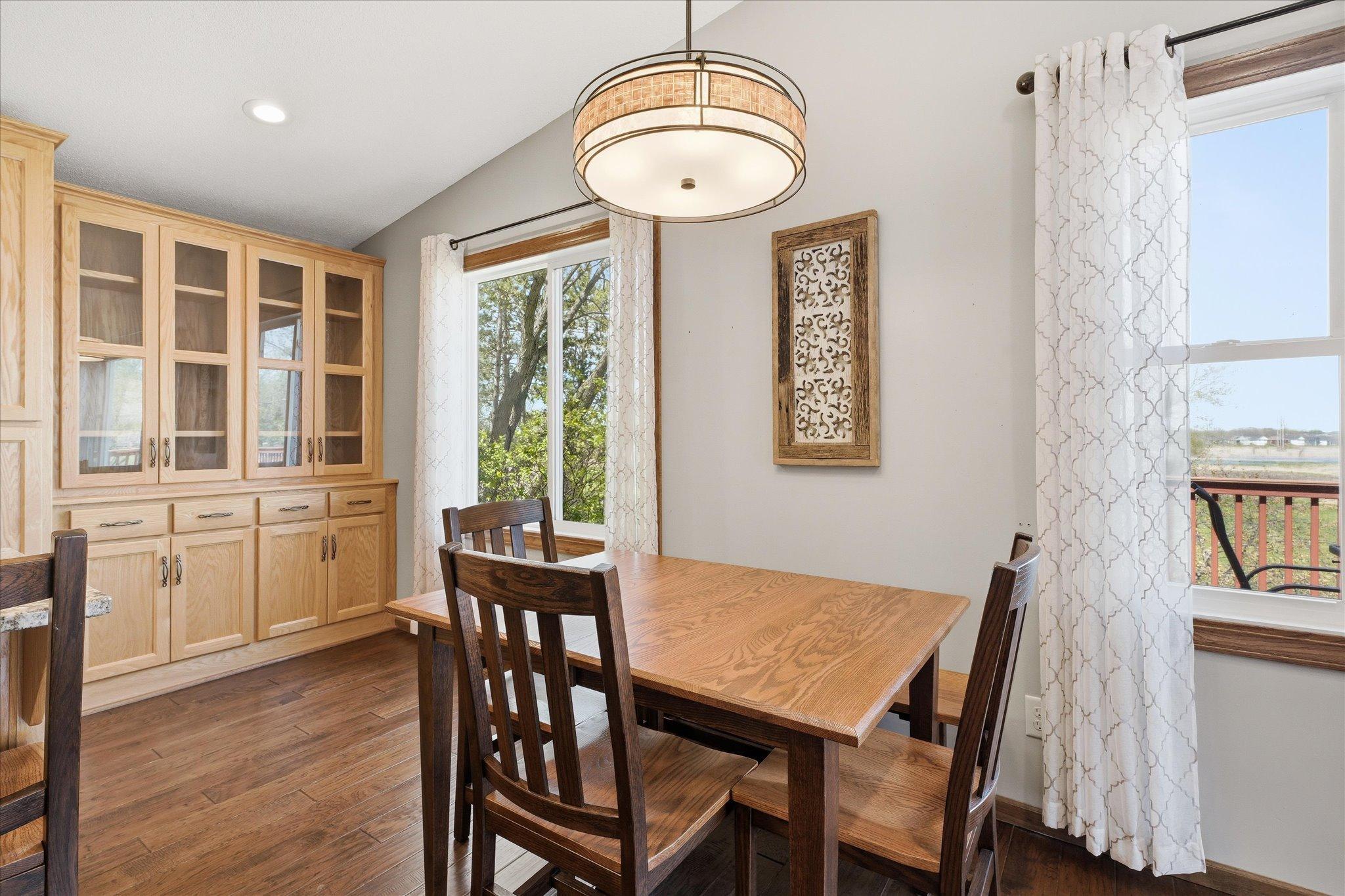 The dining area has sunlight galore and includes the beautiful hutch with glass doors to show off all your favorite glassware and favorite pieces.