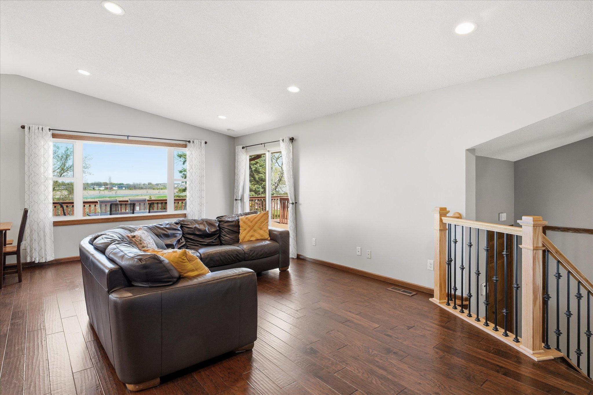 Notice the gorgeous engineered hardwood flooring and custom railing.