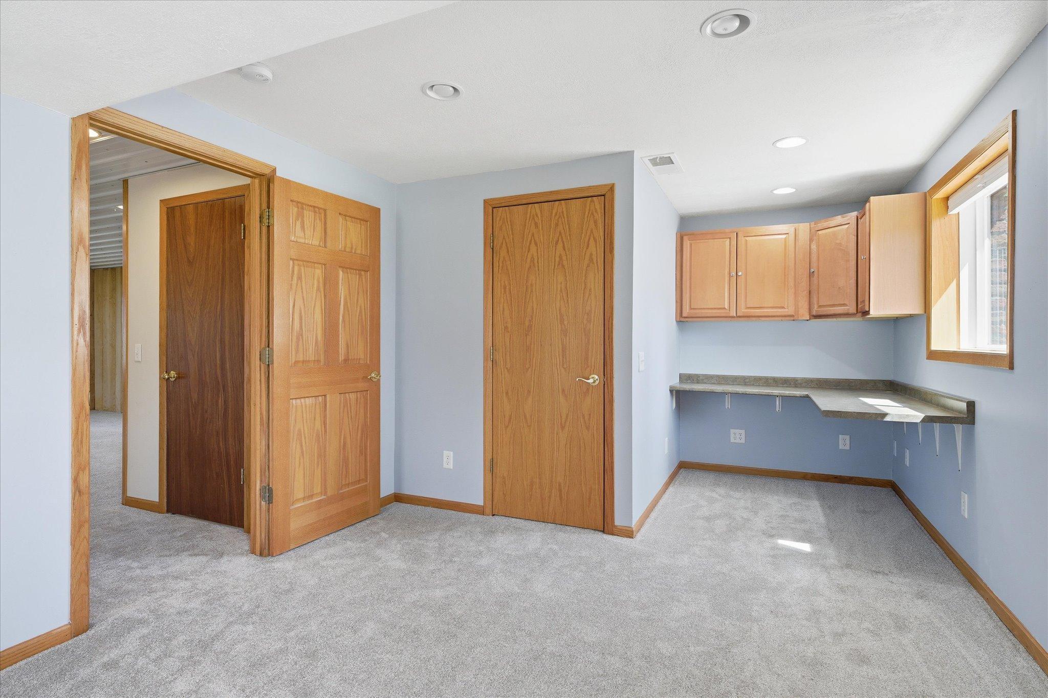 Another view of the large lower level bedroom with walk in closet plus an office nook.