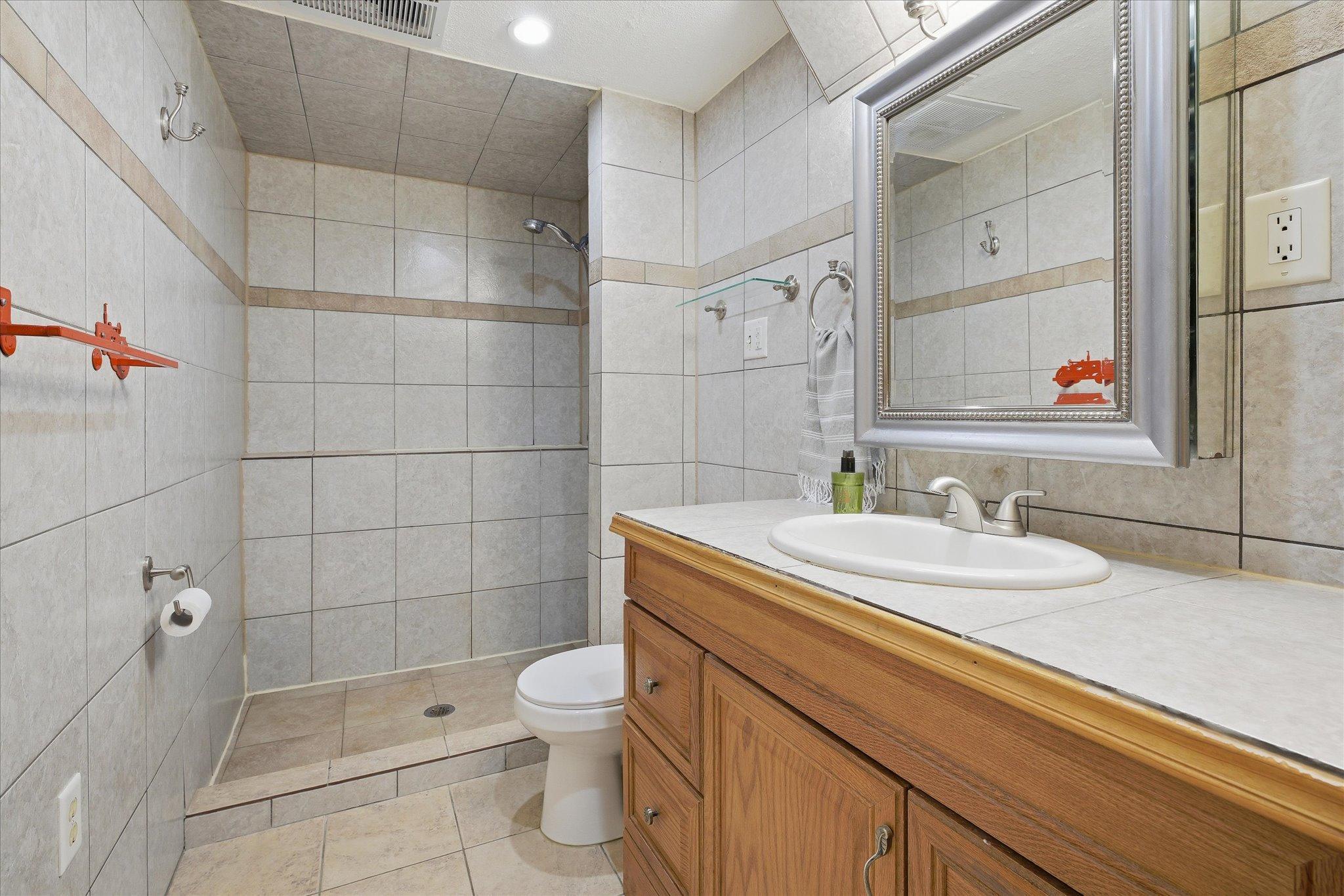 View of the 3/4 bath in the lower level with tile and a heated floor.