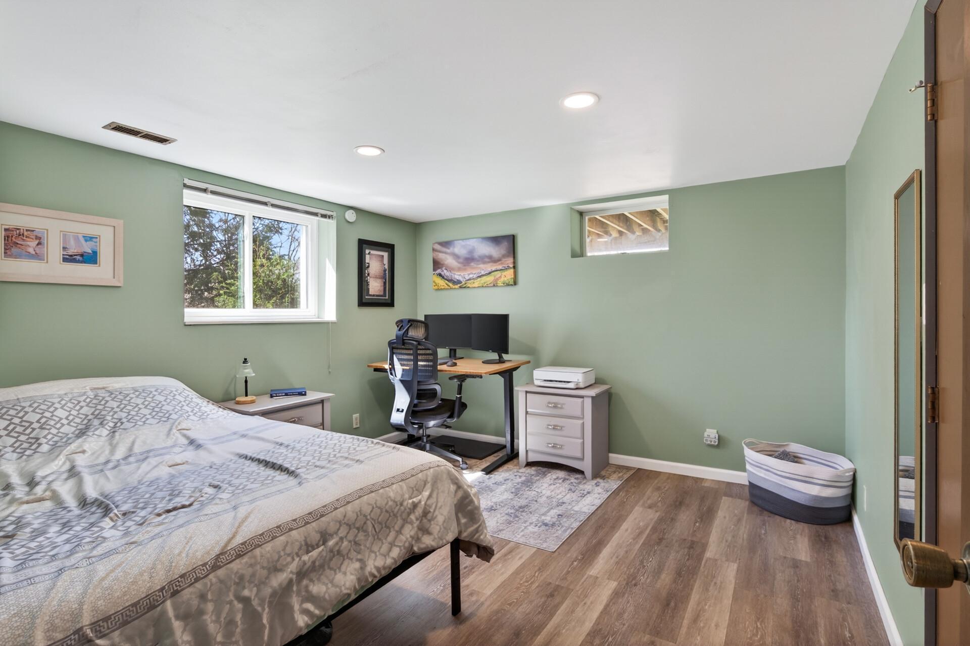 The lower level bedroom is perfect for a private guest retreat or can easily serve as a home office, gym, or flex space.