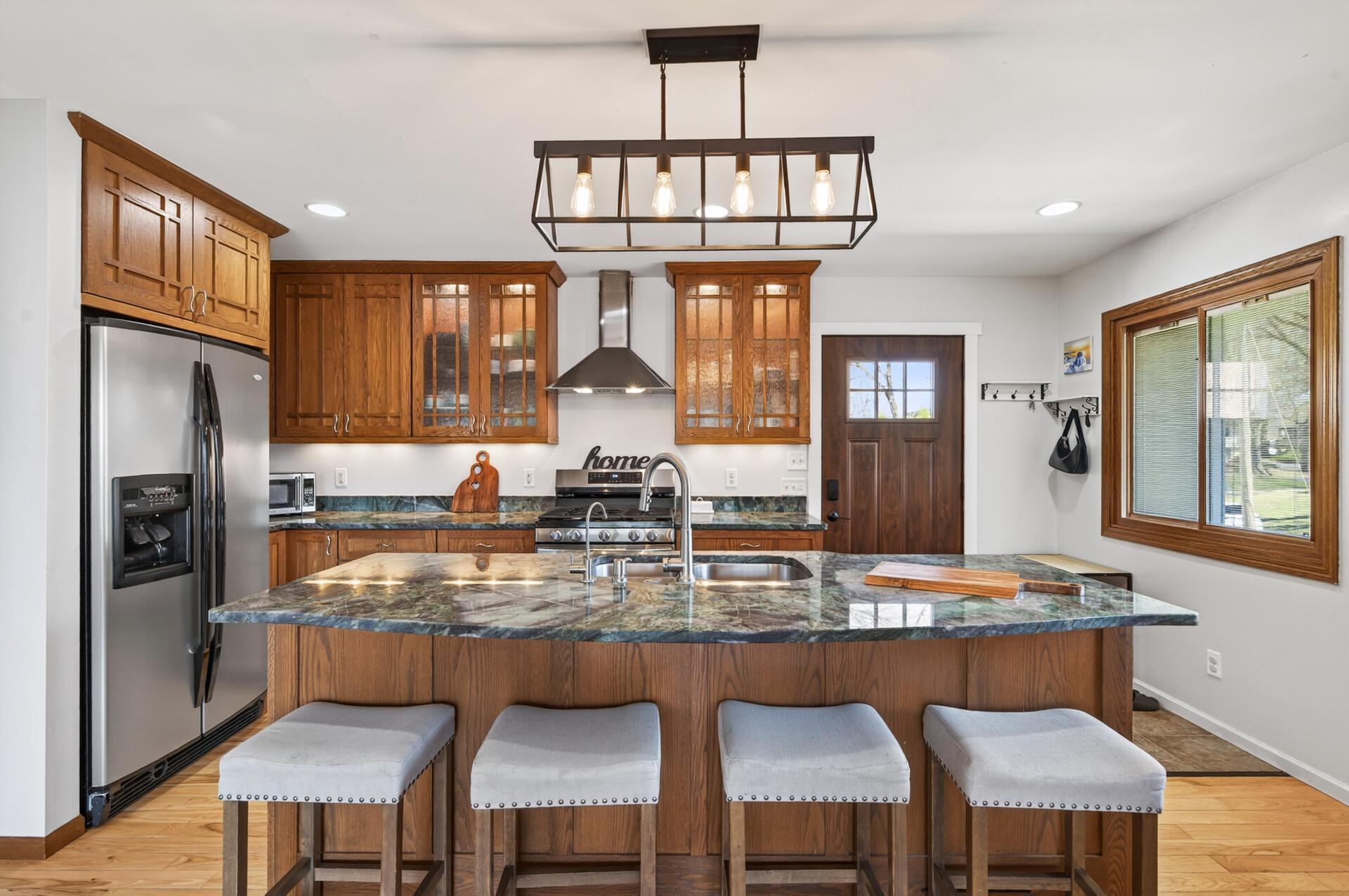 The center island provides extra prep space and storage while serving as a natural gathering spot.