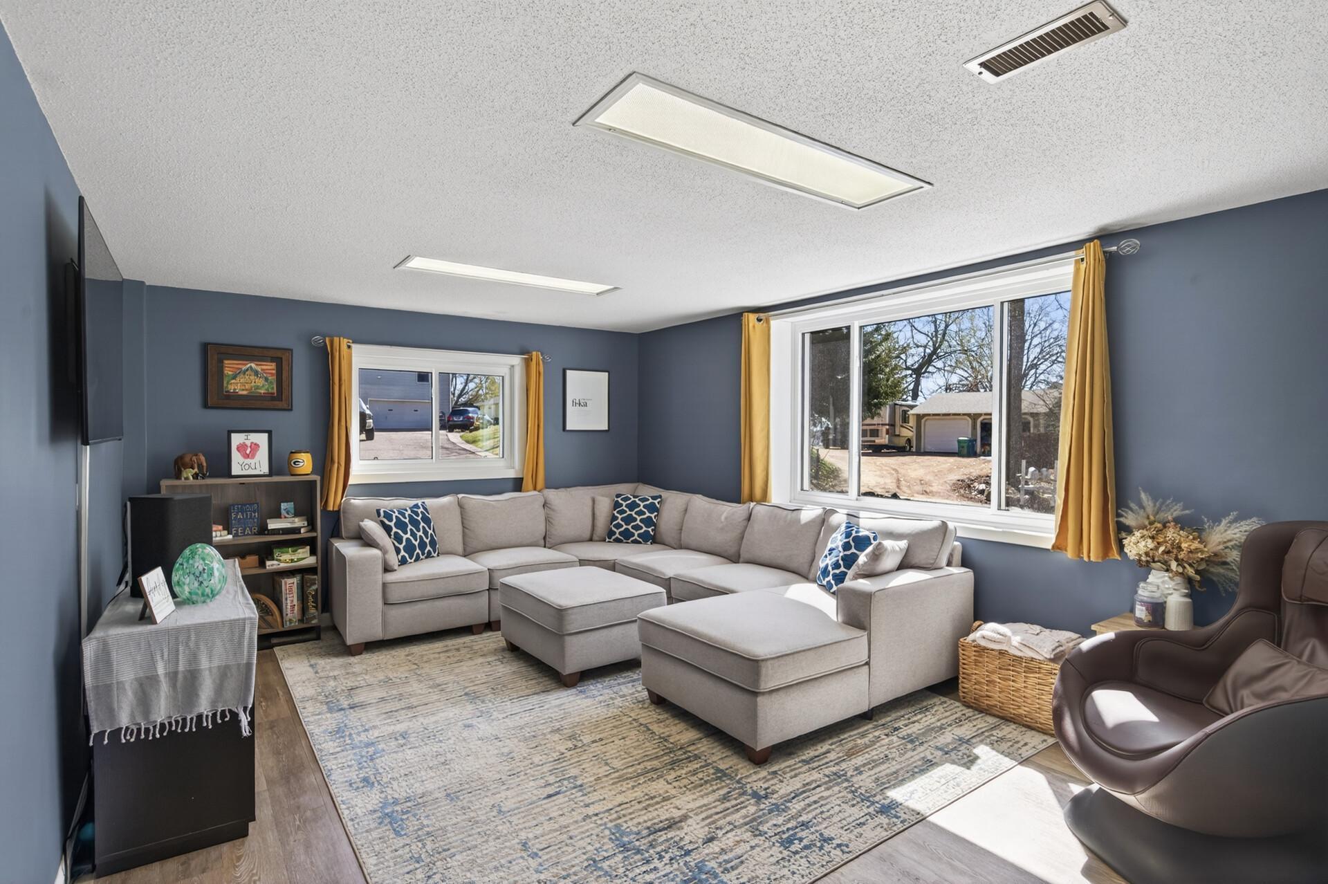 Downstairs, the lower level provides additional living space with a cozy family room.