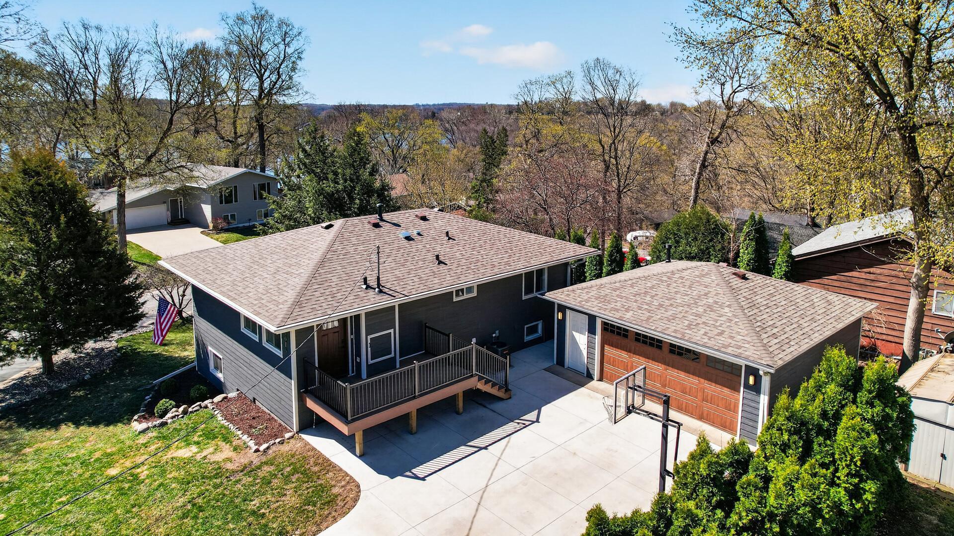 Exterior improvements include newer roof, siding, trim, windows, and a new concrete driveway that has been expanded and extended.