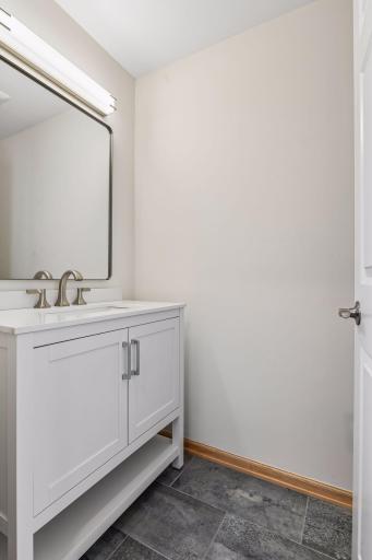 Main level 1/2 bathroom with ceramic tile flooring.