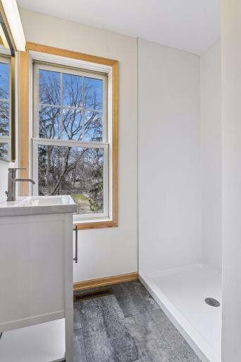 All bathrooms are completely renovated with new vanities, new showers, toilets, and tile or LVP flooring. This is the hallway bath that was just added. Brand new, never used! A blind has been added to the window (not pictured).