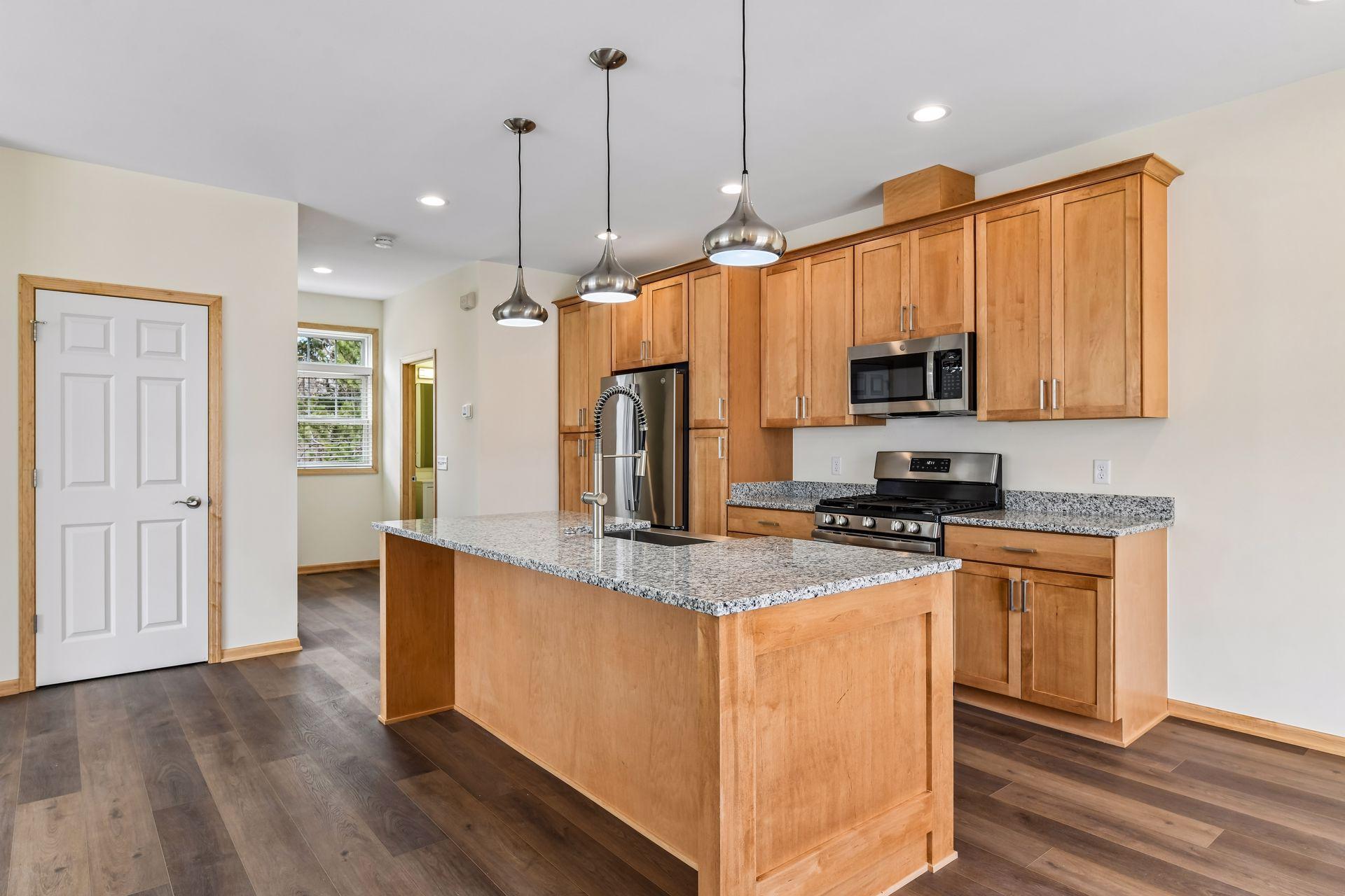 Stunning kitchen with granite countertops and stainless steel appliances.