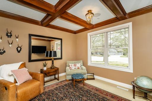 Den features a rich wood coffered ceiling.jpg