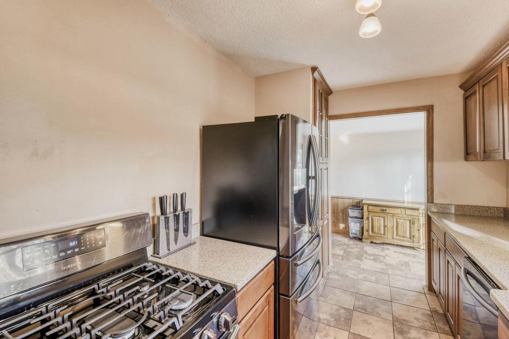 Black stainless appliances including gas range