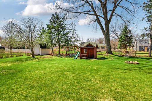 Adorable play house and swing set view from the deck. Additional storage in the 10x12 shed