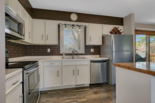 Stainless Steel appliances and sink window to view the backyard