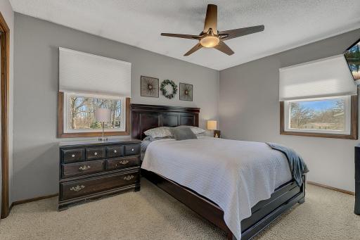 Primary bedroom has great natural light, updated lighting/ceiling fan