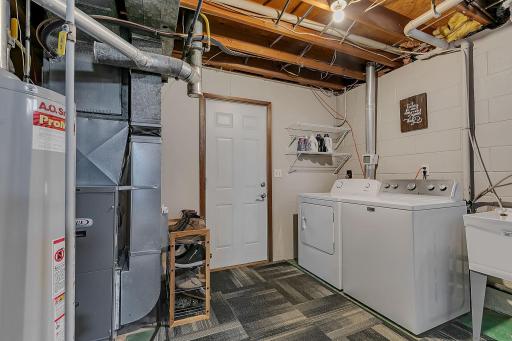 Nice size laundry/ mudroom with access to the tuck under garage + great storage