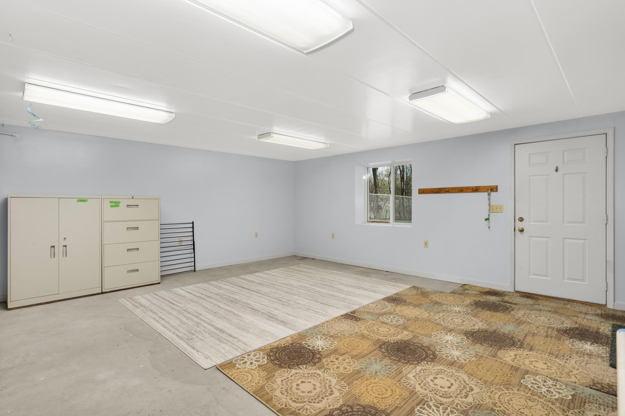 Walk out and window....this room just needs flooring. Electric wall heating unit.