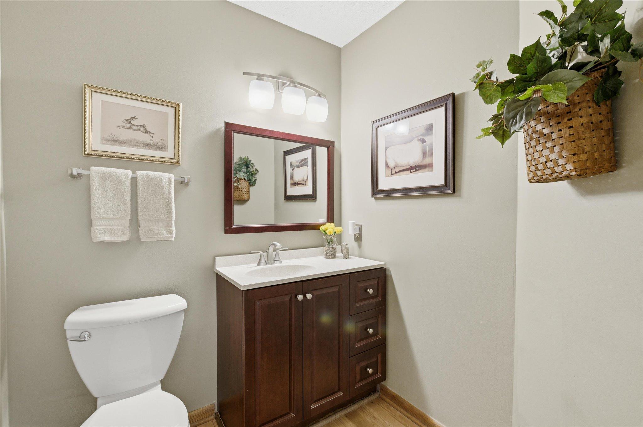 Updated half bathroom on the main level with newer vanity, lighting and fixtures.