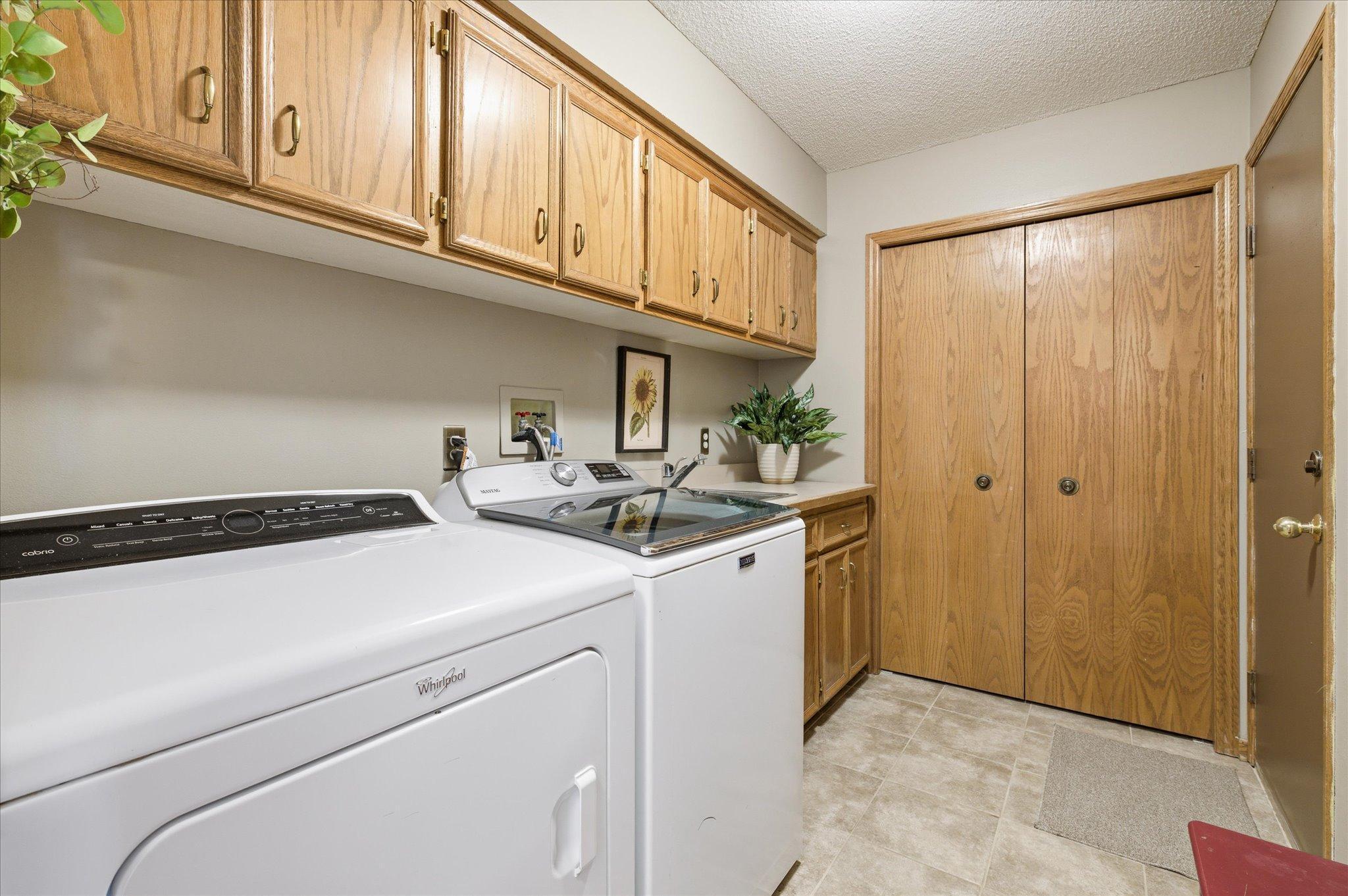 Entrance from garage/ mudroom area/laundry. Coat closet, lots of storage and utility sink. Washer and Dryer stay with the home.