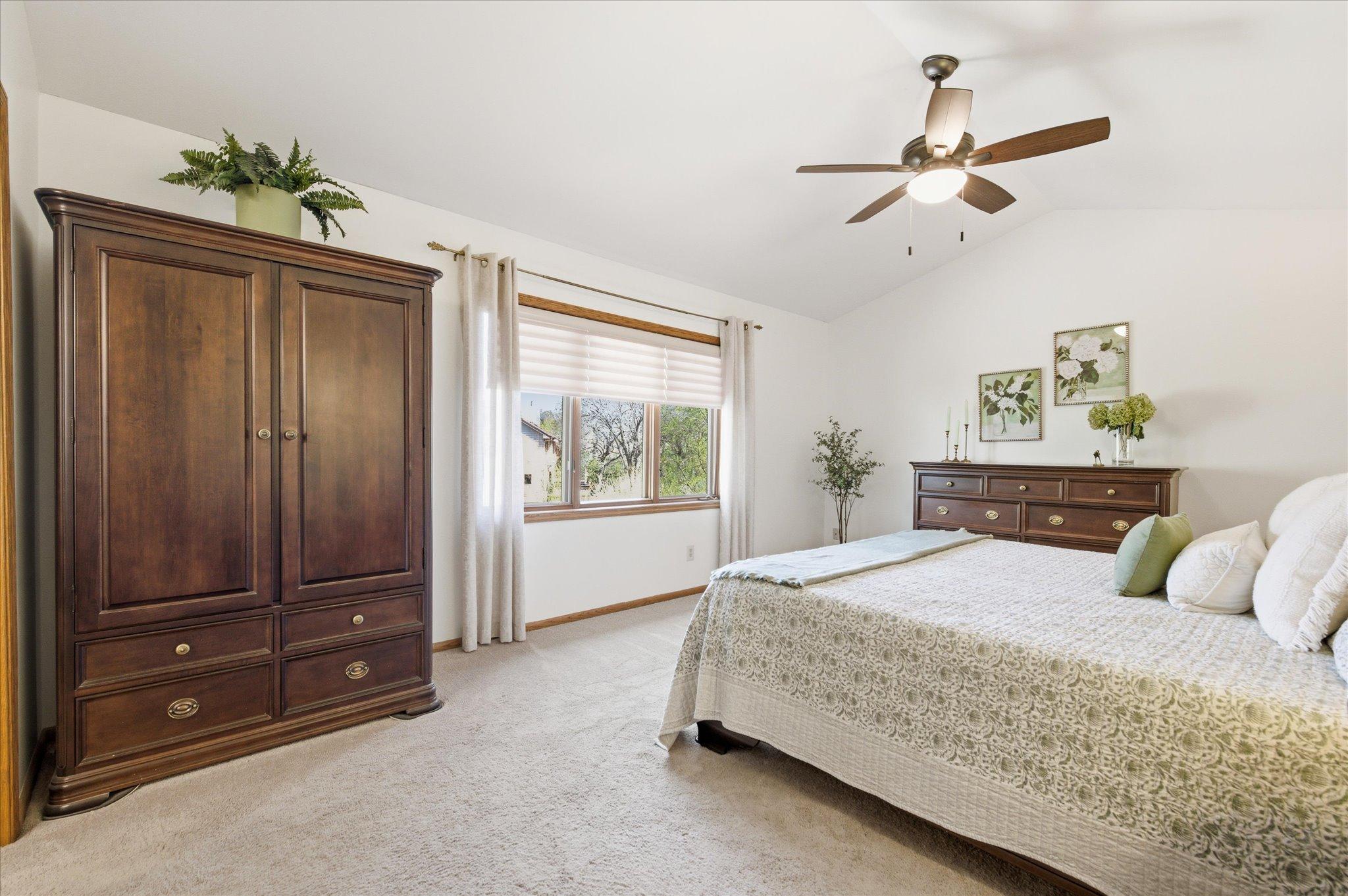 Head upstairs where you'll find four bedrooms including this large primary suite that features a brand-new ceiling fan!