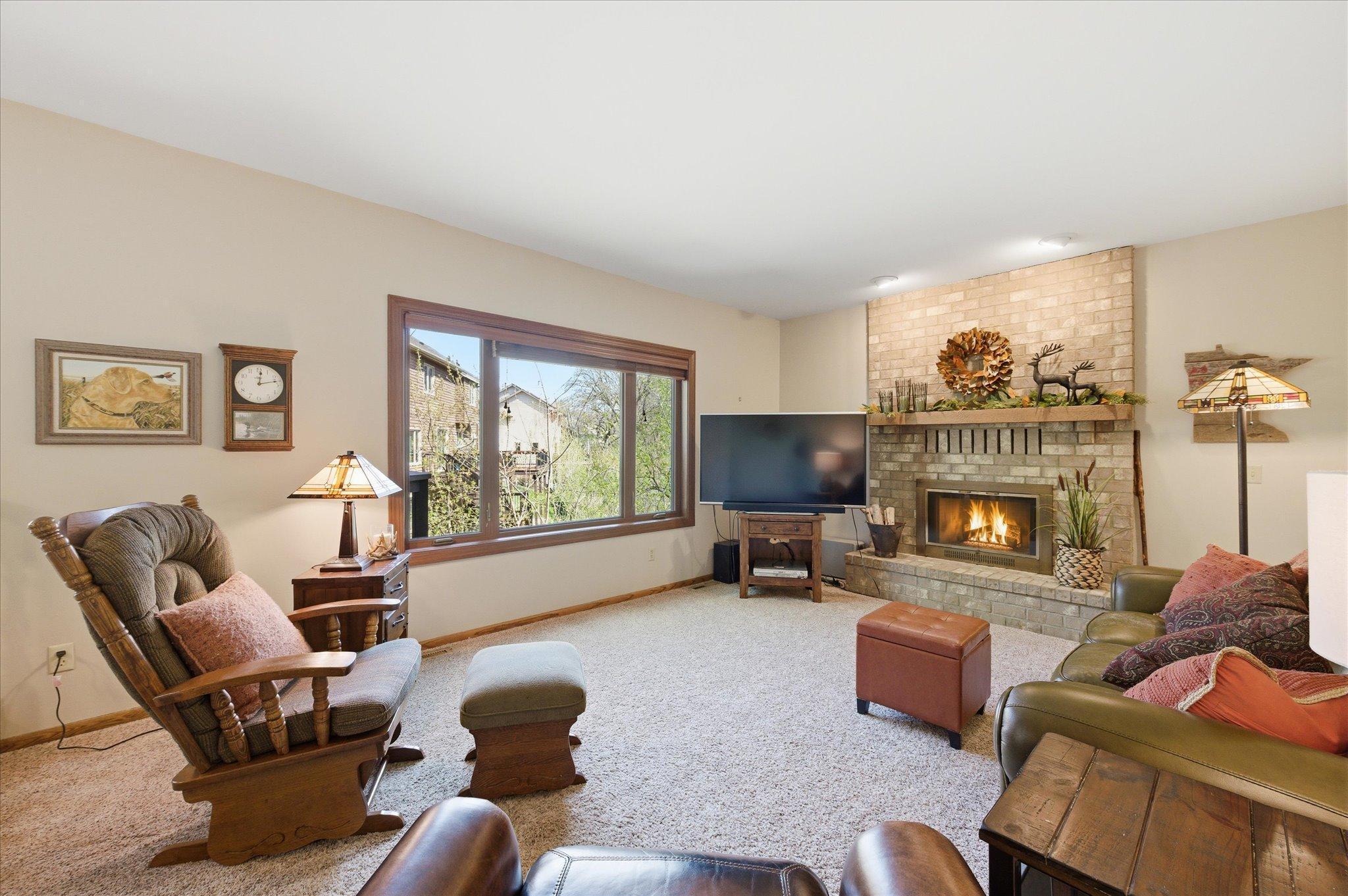 The large family room on the main level plenty of room for lots of furniture and a woodburning fireplace.