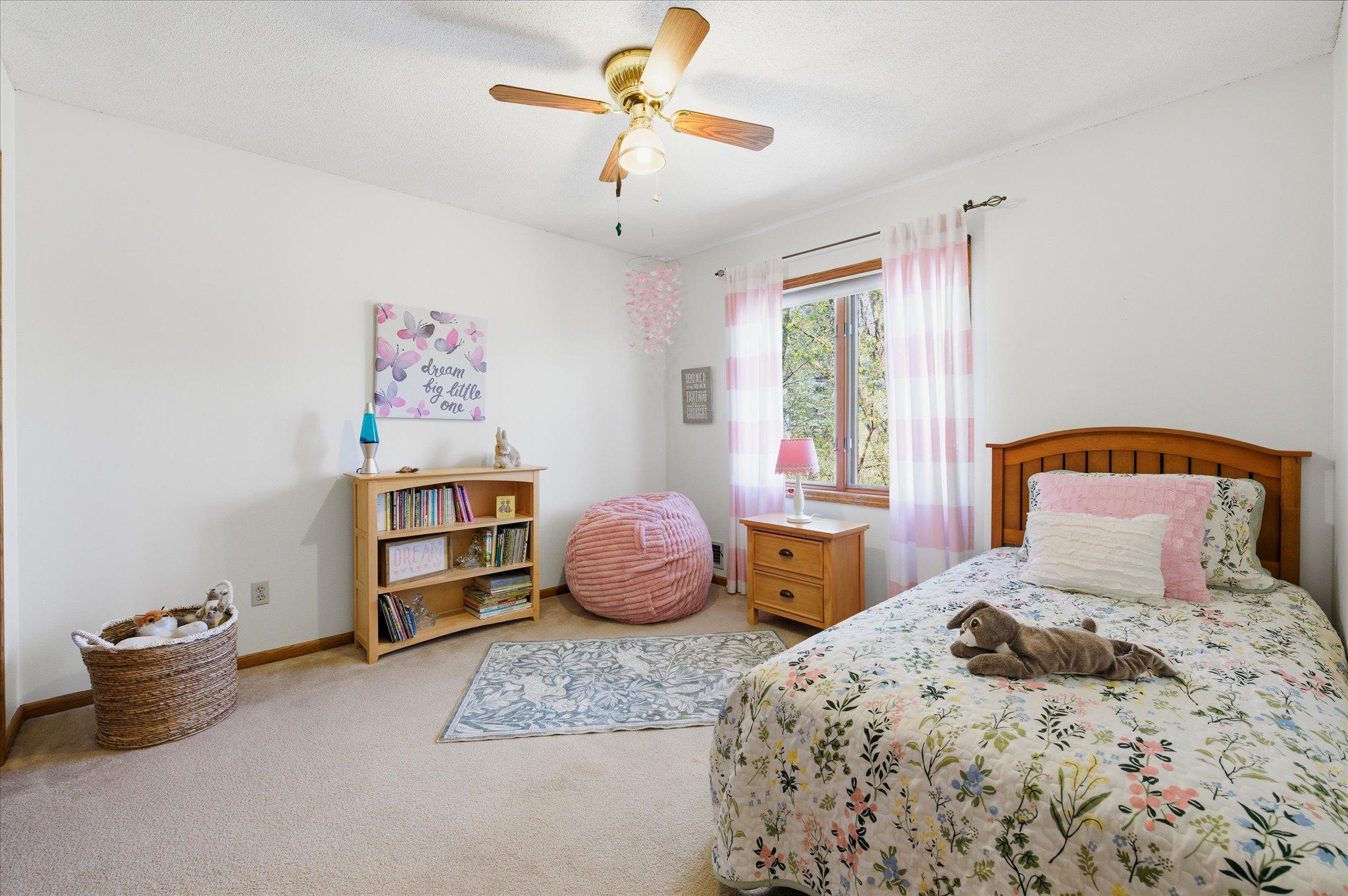 Bedroom #3 on the upper level with a ceiling fan.