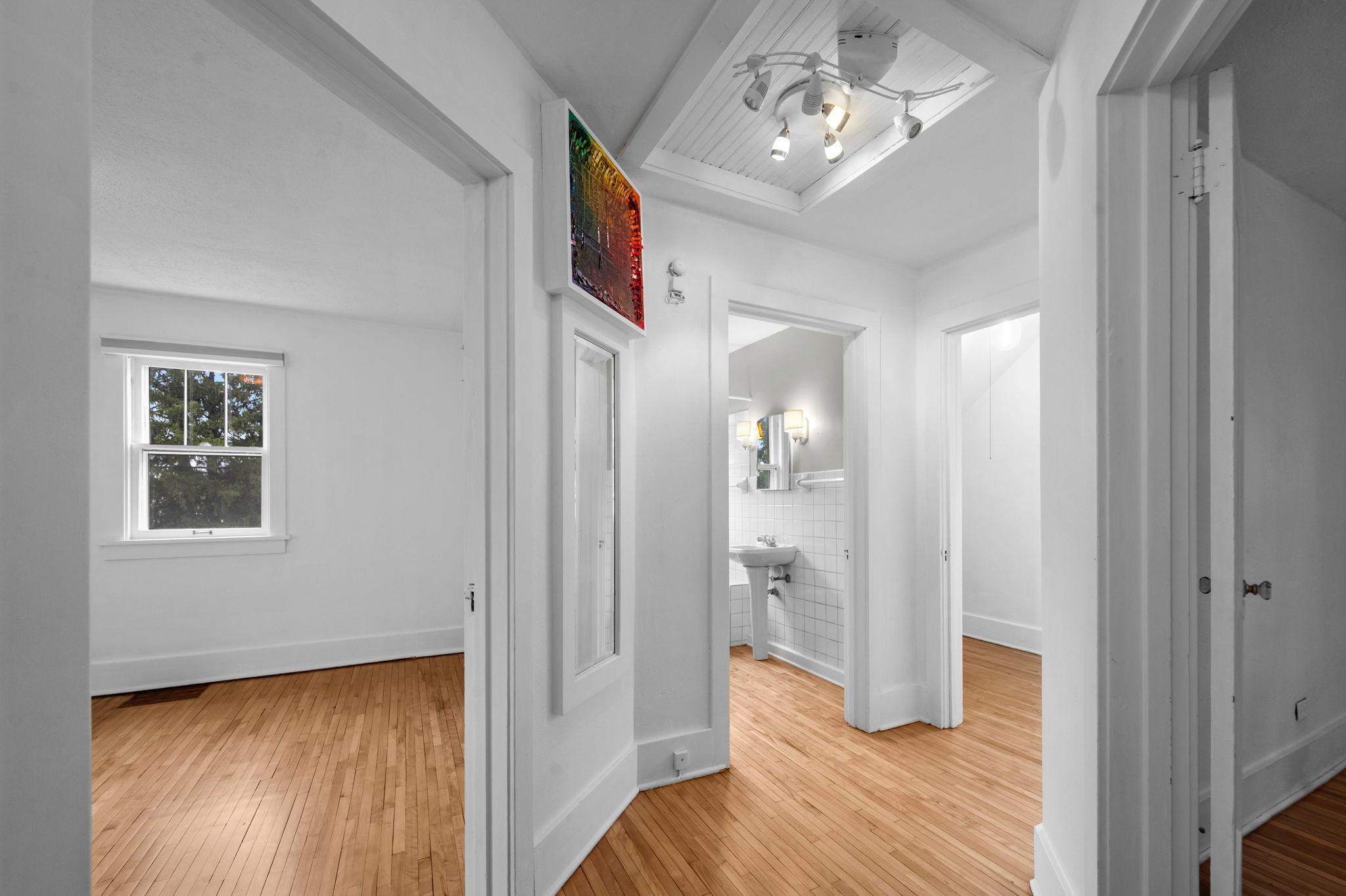 Upstairs includes three well-sized bedrooms, all with timeless wood flooring.