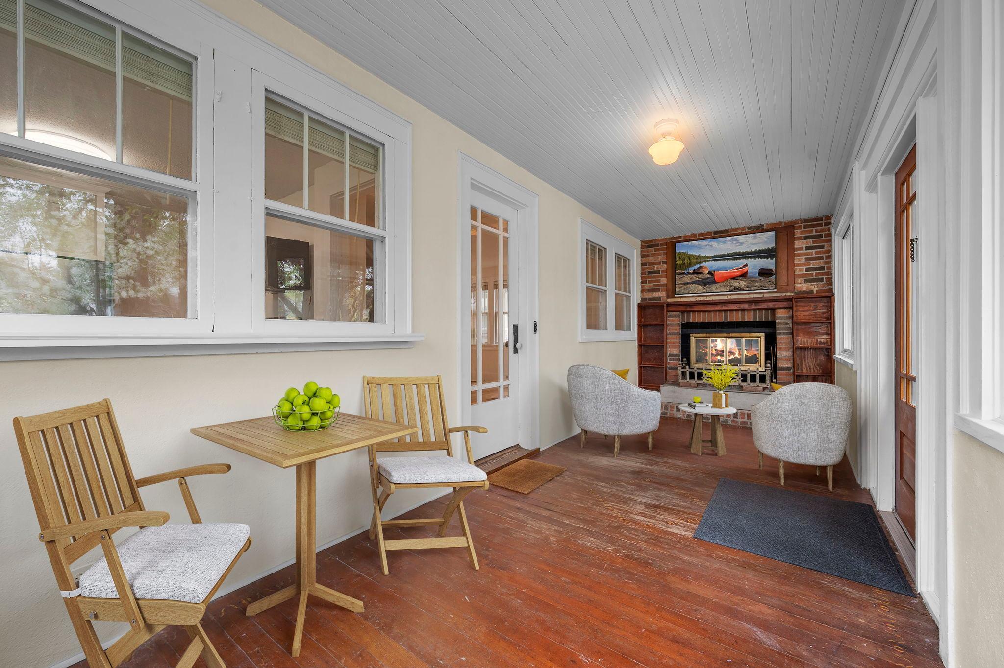 The welcoming sunroom entry with a wood-burning fireplace creates a cozy first impression.