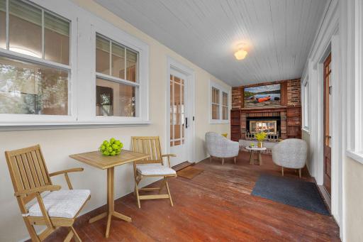 The welcoming sunroom entry with a wood-burning fireplace creates a cozy first impression.