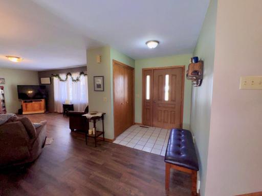 Large entry with tiled floor and a coat closet