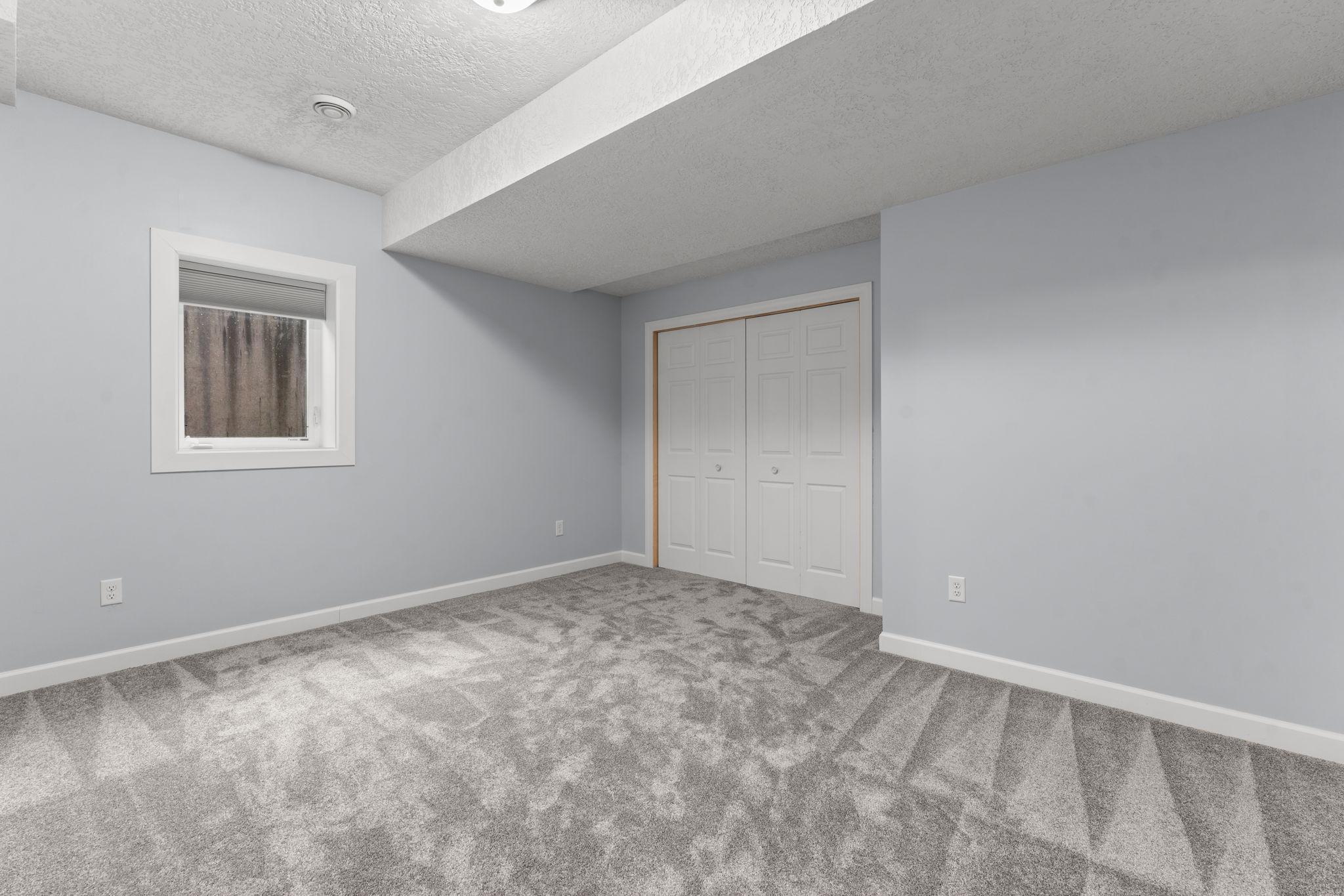 Bedroom four, located across the hall from bedroom three, is also generously sized and features cozy carpeting.