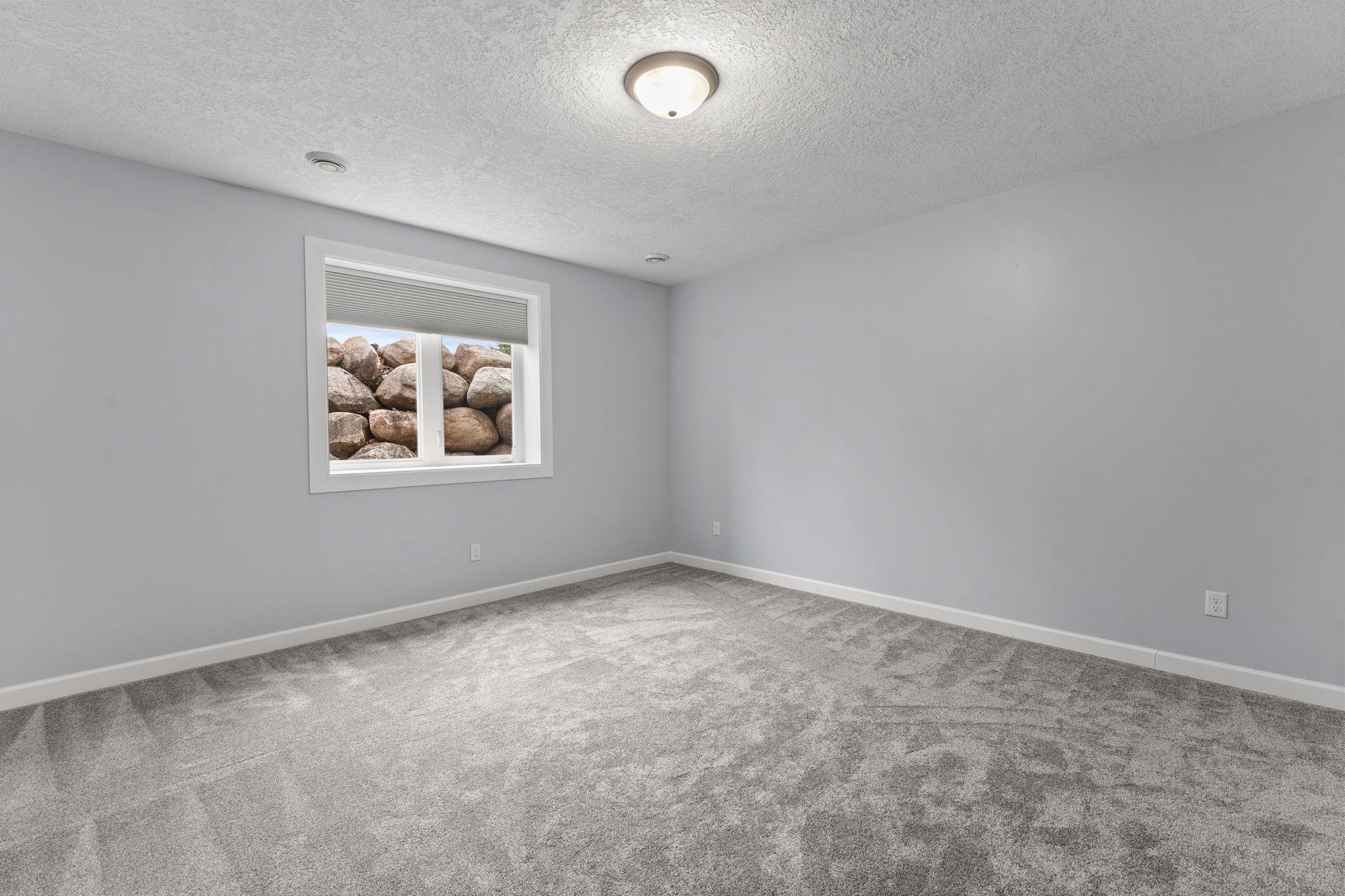 The spacious third bedroom located on the lower level.