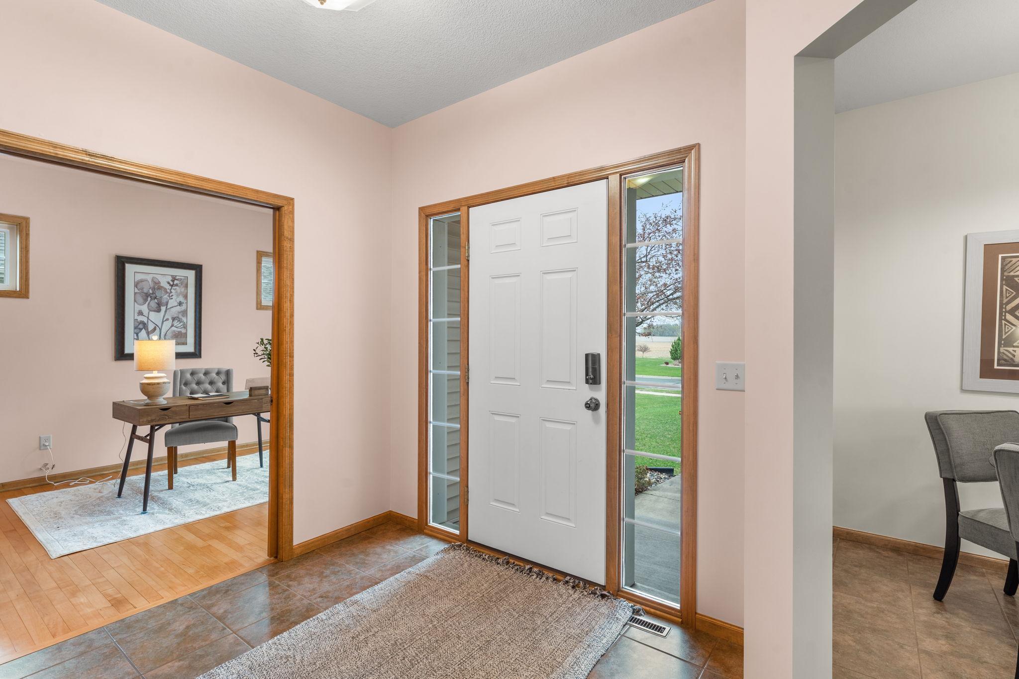 A view of the inviting front entry, featuring tile flooring and a convenient entry closet.